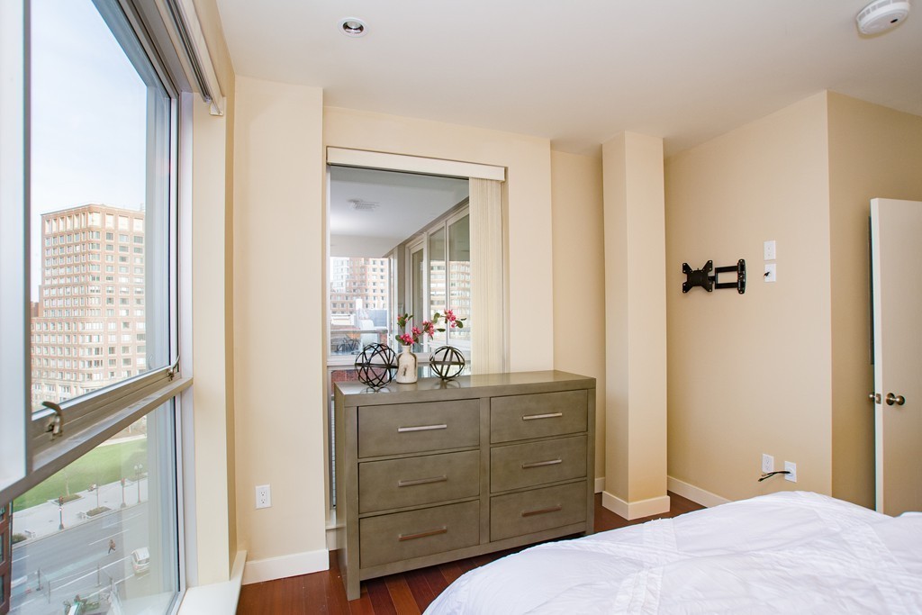 99-105 Broad Street, Unit 8C Boston, MA 02110 - Photo 10 of 28 a bedroom with a bed and a dresser
