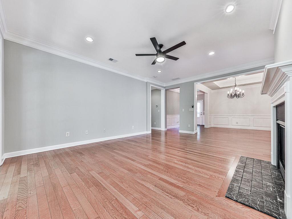 626 Laurel Crossing Canton, GA 30114 - Photo 17 of 77 a view of empty room with wooden floor and fan