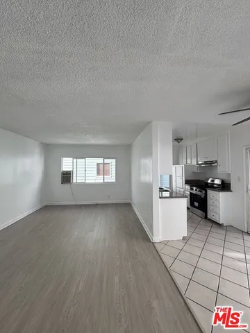 a kitchen with cabinets and window
