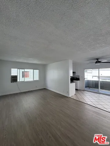a view of a room window and wooden floor