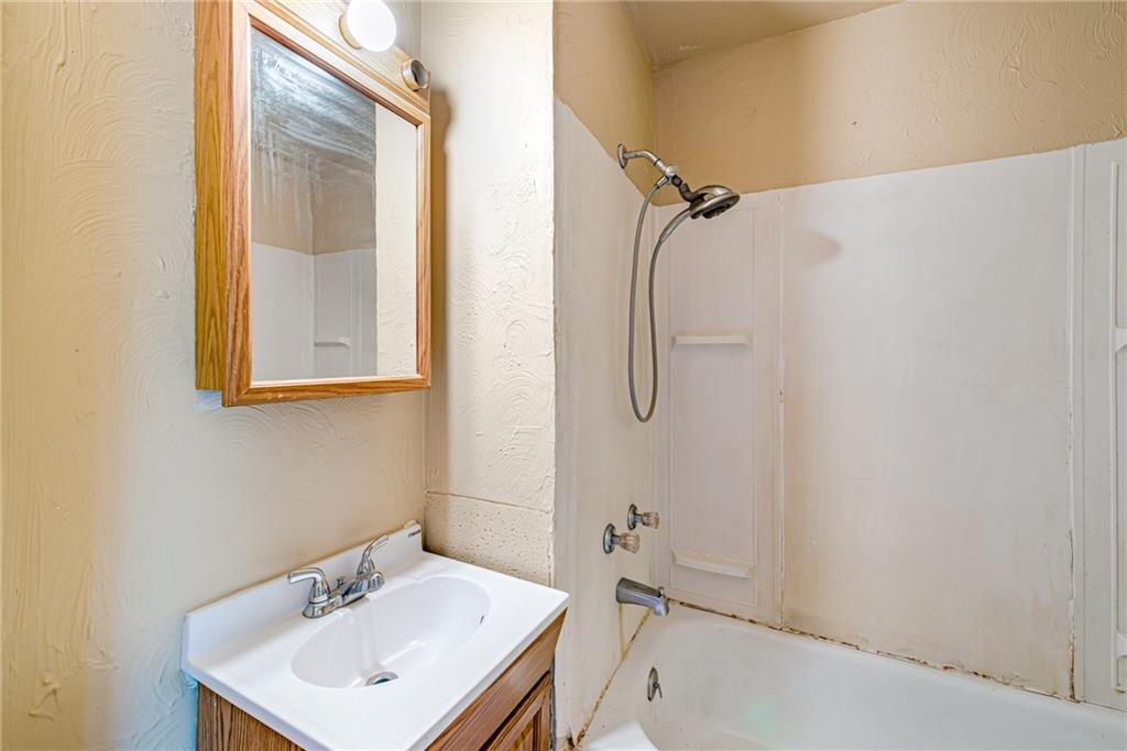 4 Howe Street Elrama, PA 15038 - Photo 16 of 29 a bathroom with a sink a mirror and a shower
