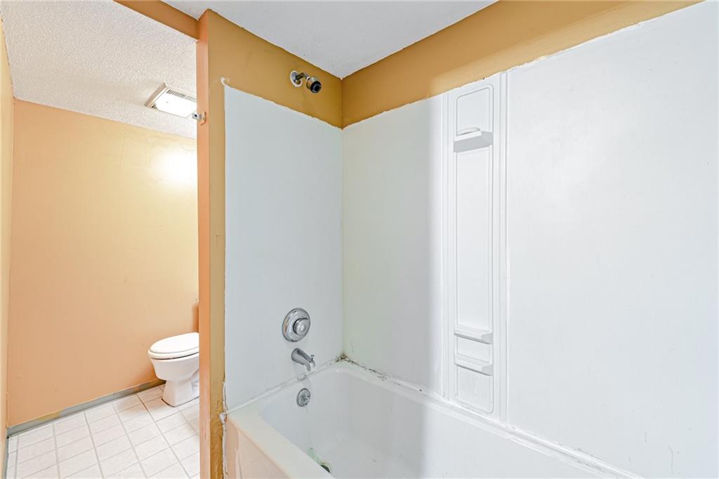 4 Howe Street Elrama, PA 15038 - Photo 23 of 29 a bathroom with a bathtub and a toilet
