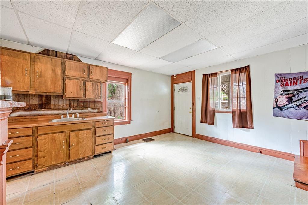 4 Howe Street Elrama, PA 15038 - Photo 6 of 29 a large white kitchen with granite countertop a large window and a sink