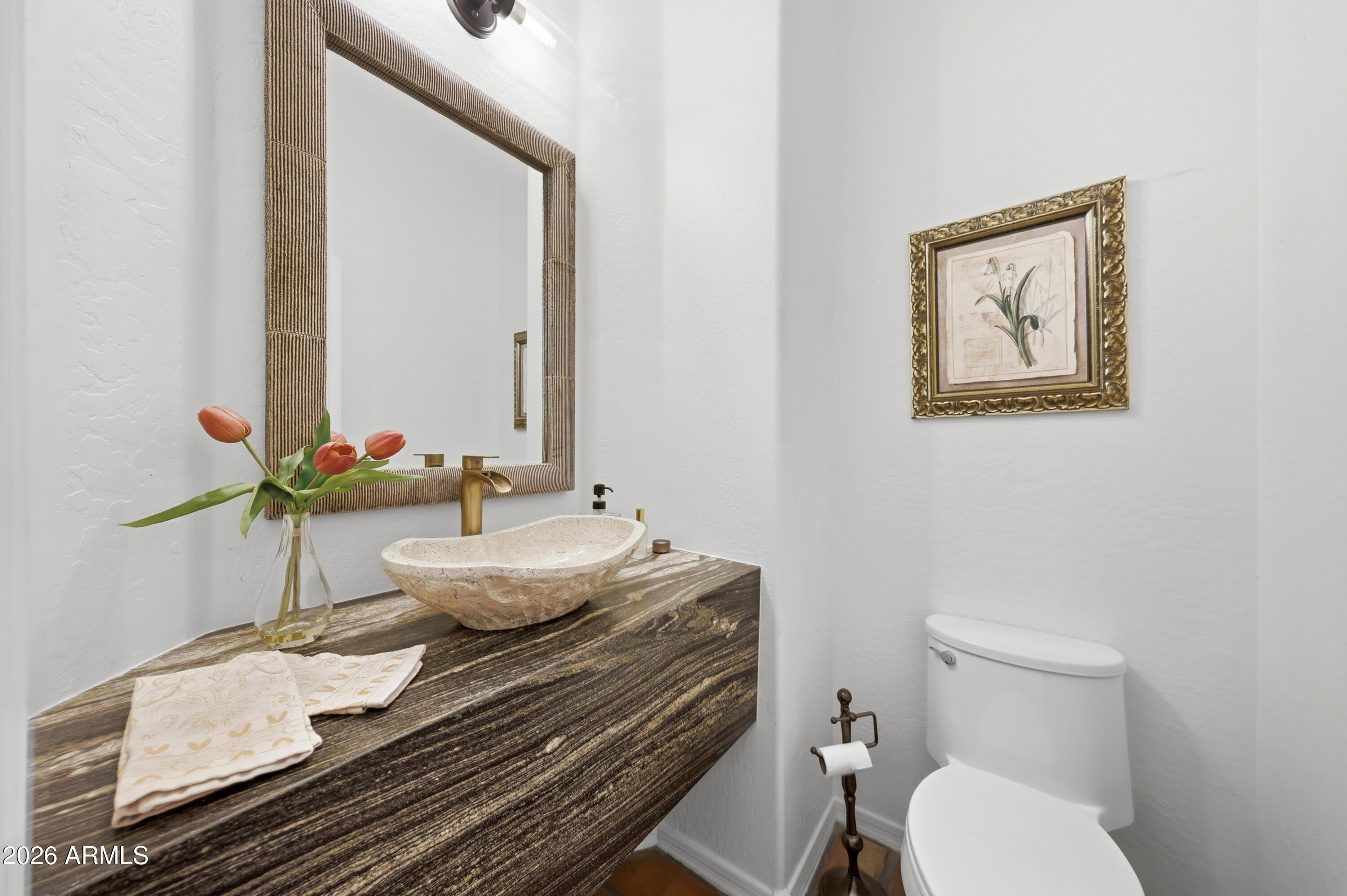 11071 East Evans Road Scottsdale, AZ 85255 - Photo 15 of 35 a bathroom with a granite countertop toilet and a mirror