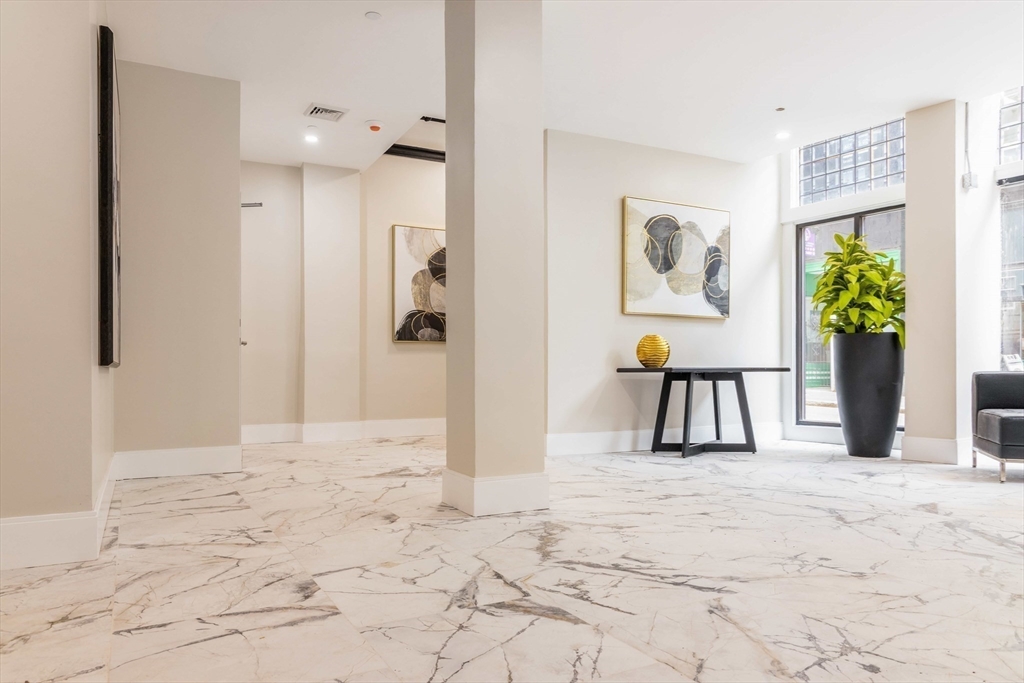 44 Bromfield Street, Unit 204 Boston, MA 02108 - Photo 6 of 7 a view of a bedroom with wooden floor and a window