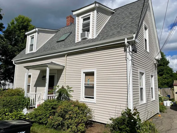 a front view of a house with plants