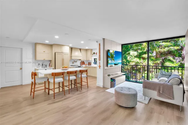 a living room with large windows and wooden floor