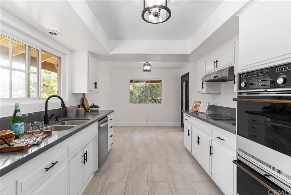 1766 North Mockingbird Place Orange, CA 92867 - Photo 13 of 39 a kitchen with granite countertop a sink stainless steel appliances and window