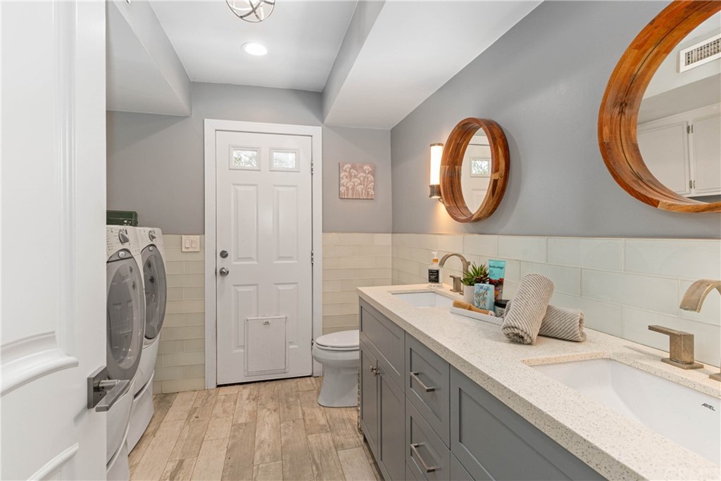 1766 North Mockingbird Place Orange, CA 92867 - Photo 16 of 39 a bathroom with a granite countertop sink vanity mirror bathtub and toilet