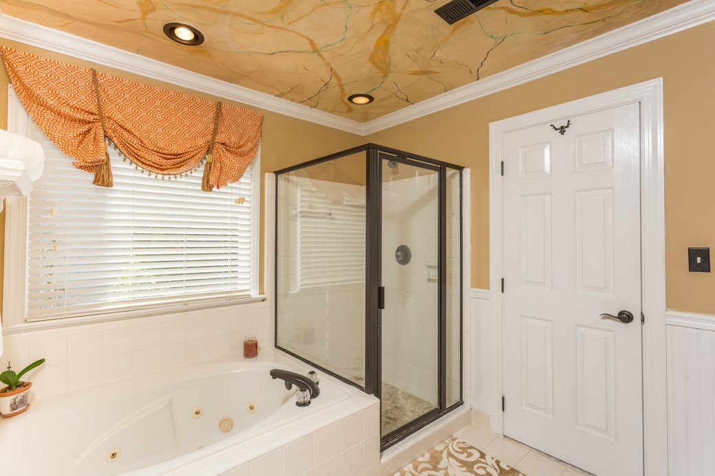 5215 Coffee Tree Drive Raleigh, NC 27613 - Photo 8 of 25 The whirlpool tub and ceramic tile shower and floor add luxury to the master bathroom Master Bath/Spa