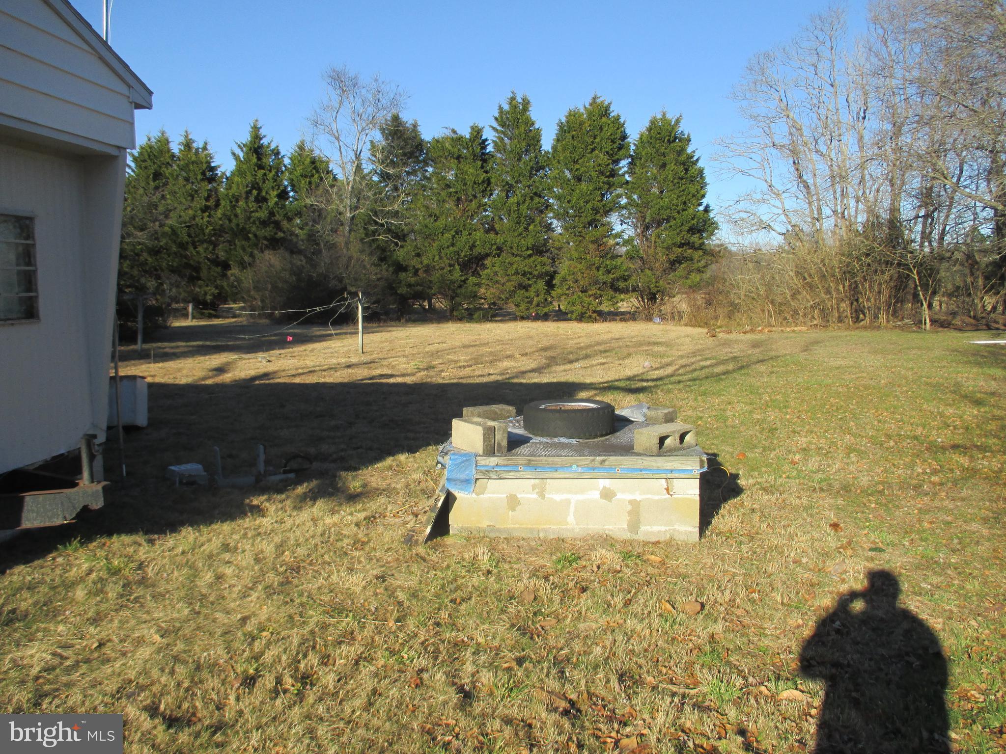 29791 Armory Road Dagsboro, DE 19939 - Photo 5 of 12 a view of a swimming pool with an outdoor space and seating area