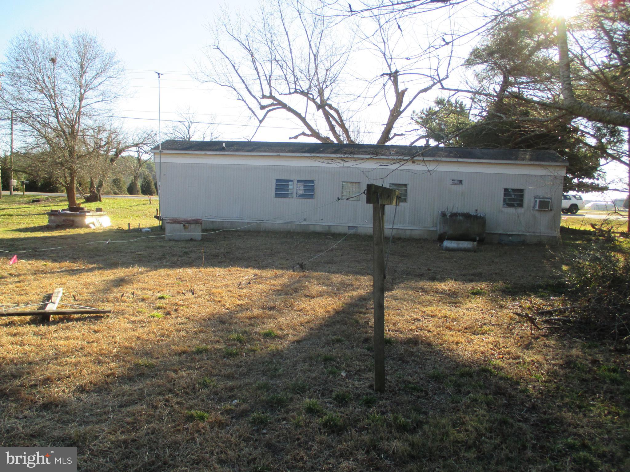 29791 Armory Road Dagsboro, DE 19939 - Photo 8 of 12 a view of a house with a yard covered in snow