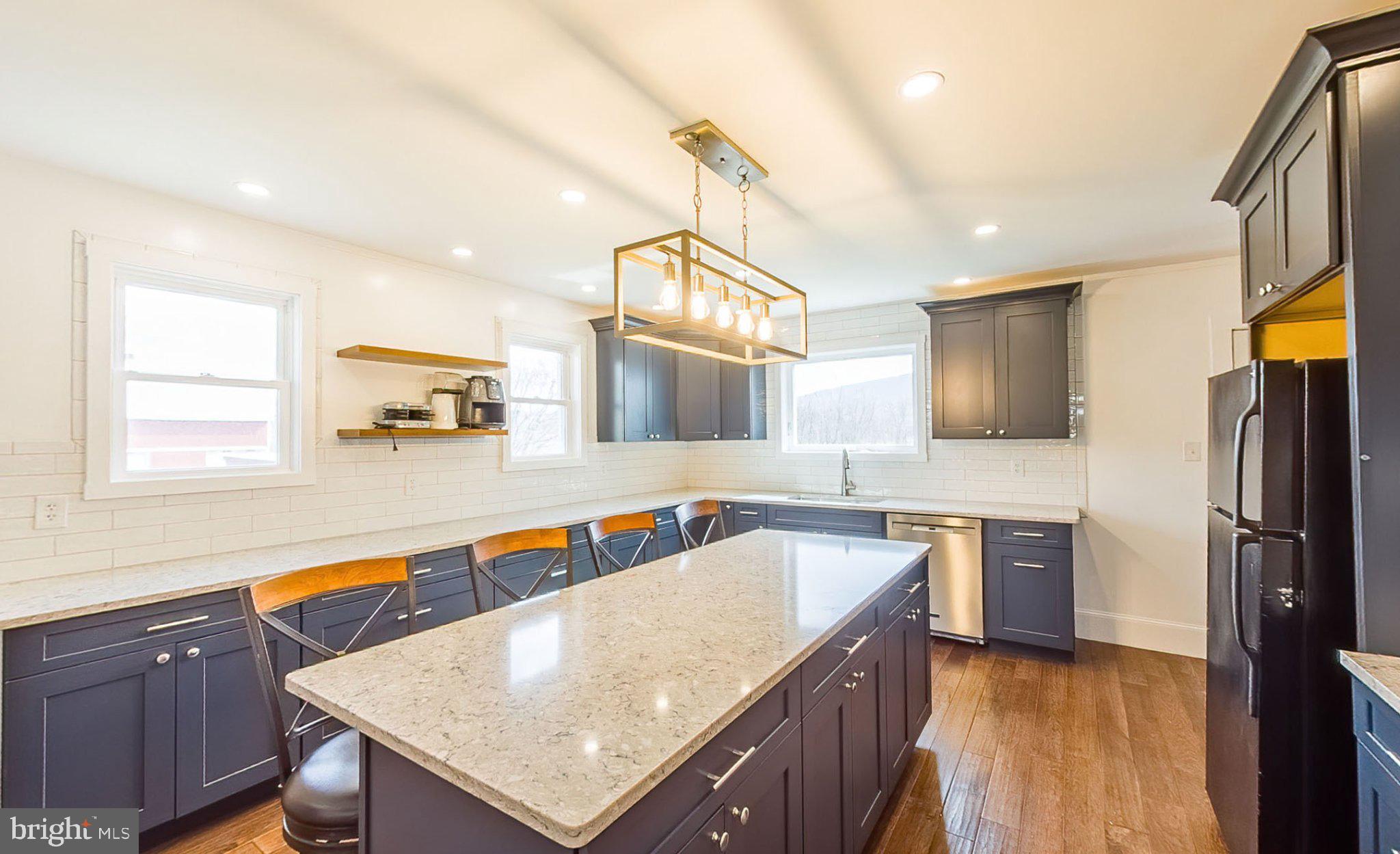 648 Main-Mifflin Road Nescopeck, PA 18635 - Photo 4 of 64 a kitchen with stainless steel appliances granite countertop a sink a stove a refrigerator cabinets and wooden floor