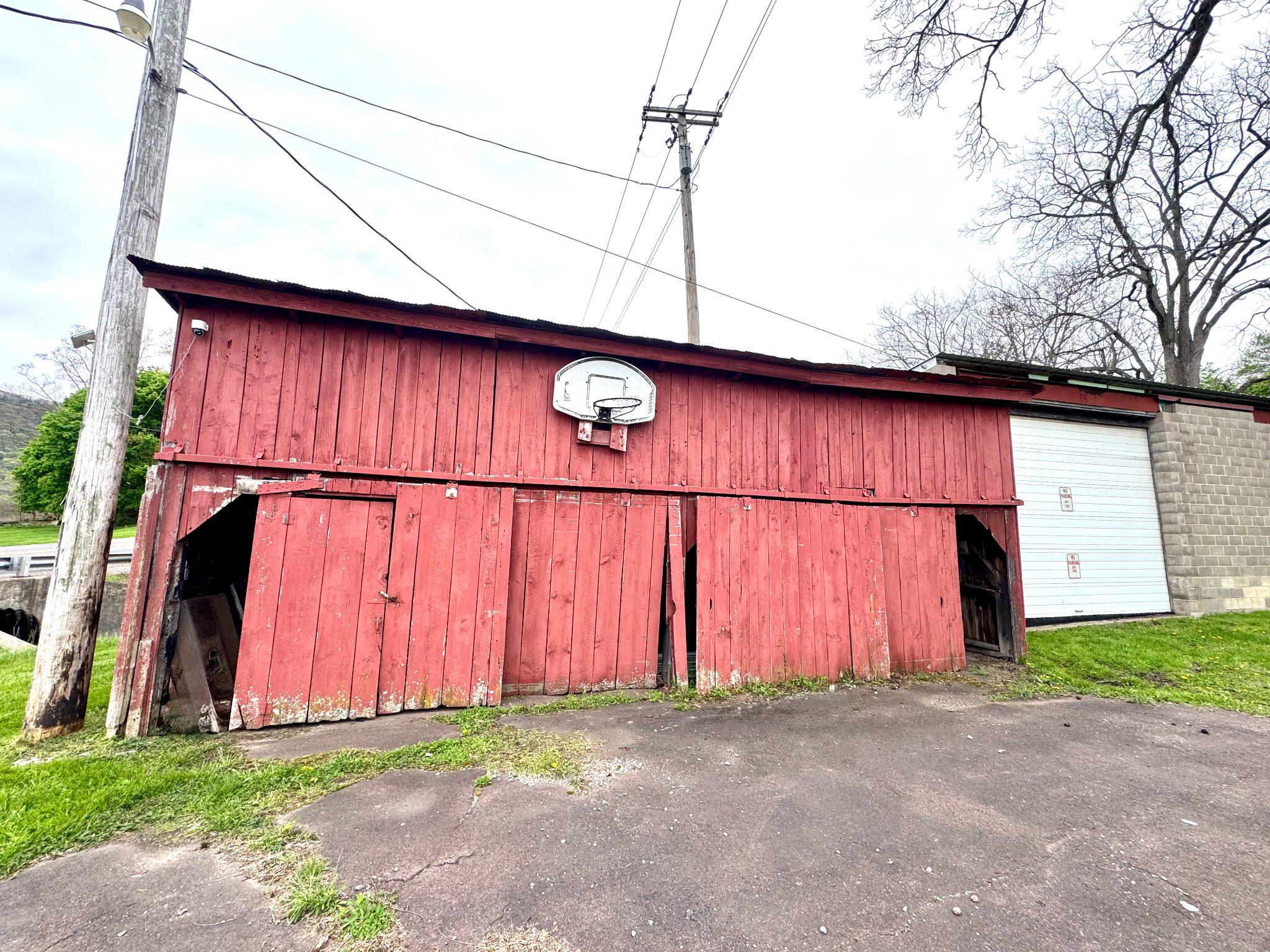648 Main-Mifflin Road Nescopeck, PA 18635 - Photo 54 of 64 Rustic red barn with a basketball hoop.