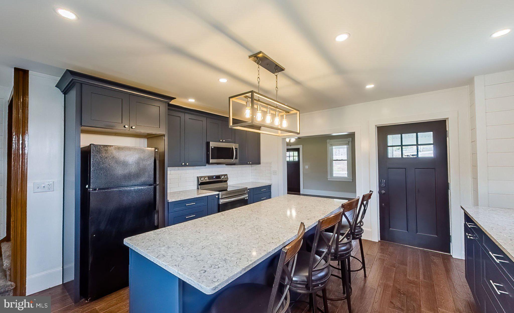 648 Main-Mifflin Road Nescopeck, PA 18635 - Photo 8 of 64 a kitchen with refrigerator a refrigerator and dining table
