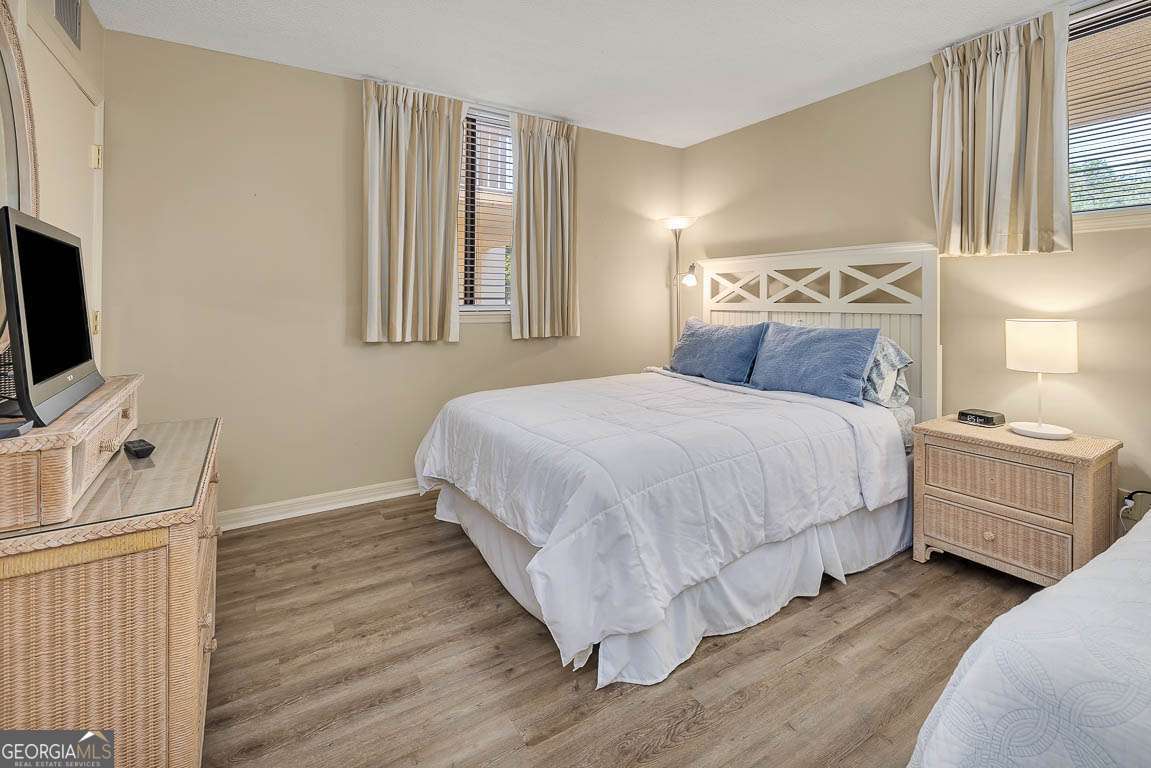 201 Neptune Road, Unit 258 St. Simons, GA 31522 - Photo 11 of 48 a bedroom with a bed and a flat screen tv