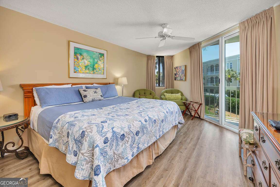 201 Neptune Road, Unit 258 St. Simons, GA 31522 - Photo 12 of 48 a bedroom with a large bed and a chandelier