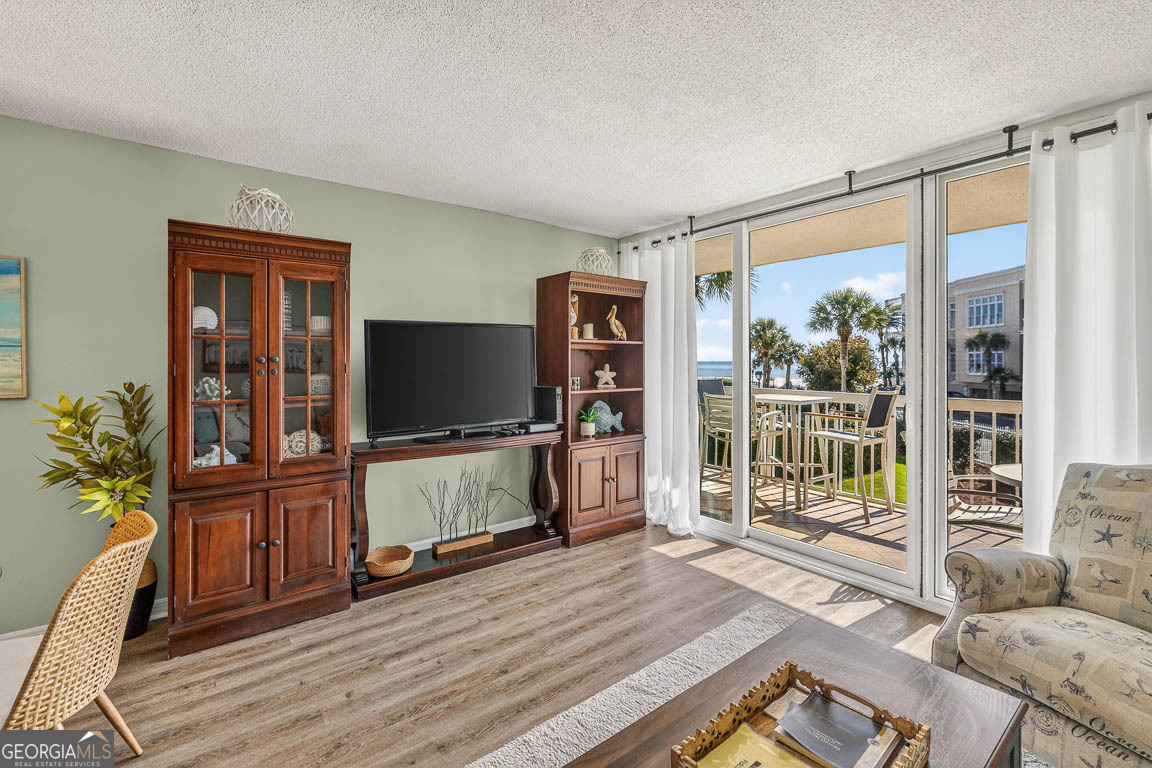 201 Neptune Road, Unit 258 St. Simons, GA 31522 - Photo 13 of 52 a living room with furniture and a flat screen tv