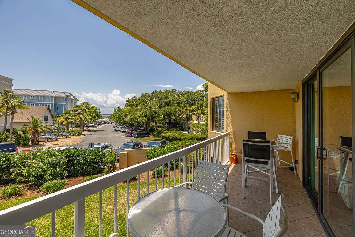 201 Neptune Road, Unit 258 St. Simons, GA 31522 - Photo 14 of 48 a view of a chairs and table in the balcony