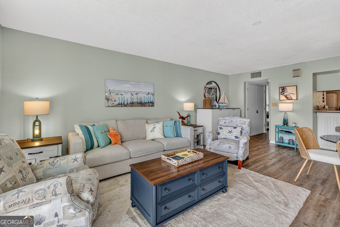 201 Neptune Road, Unit 258 St. Simons, GA 31522 - Photo 14 of 52 a living room with furniture and a couch
