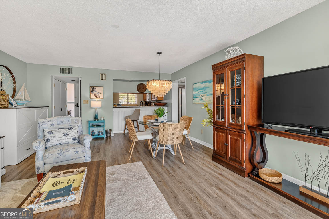 201 Neptune Road, Unit 258 St. Simons, GA 31522 - Photo 15 of 52 a living room with furniture and a flat screen tv