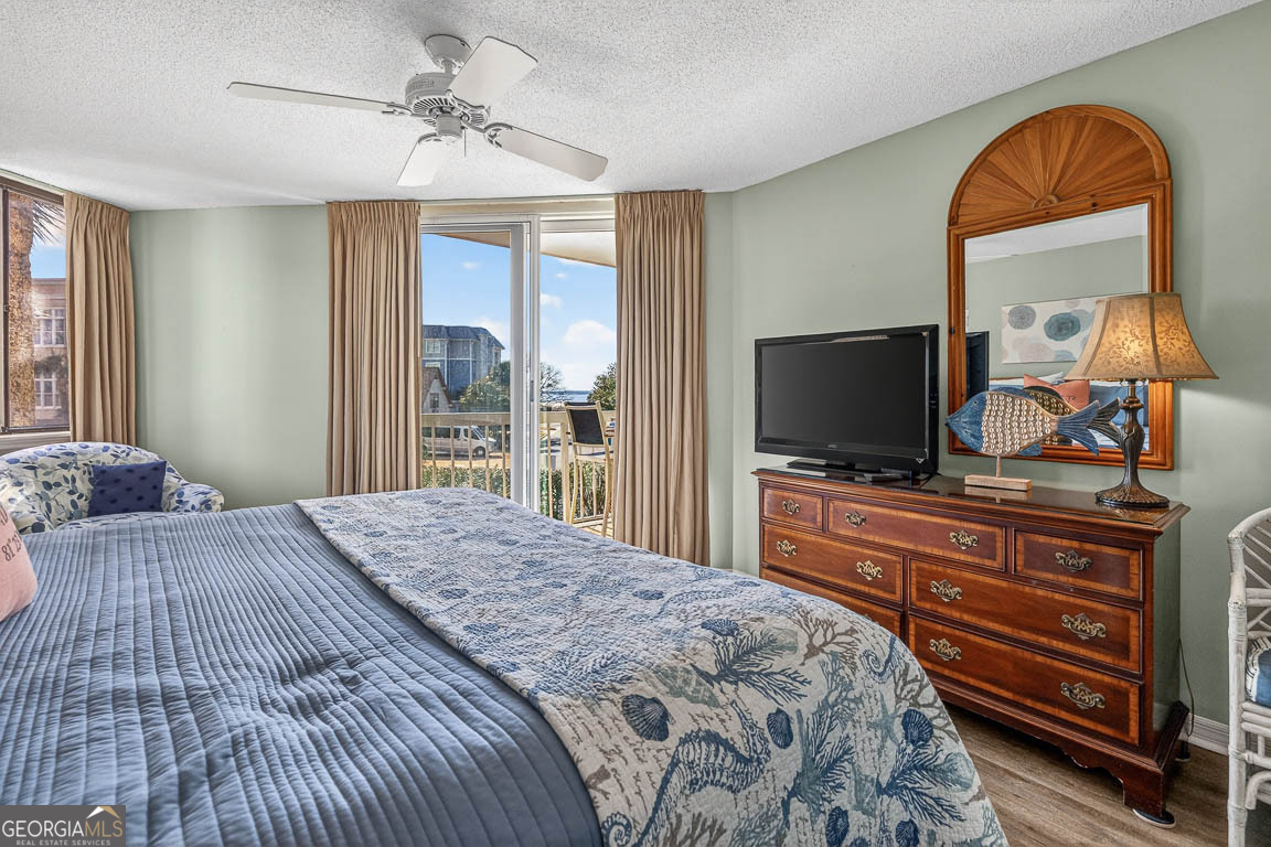 201 Neptune Road, Unit 258 St. Simons, GA 31522 - Photo 20 of 52 a bedroom with a bed and a flat screen tv