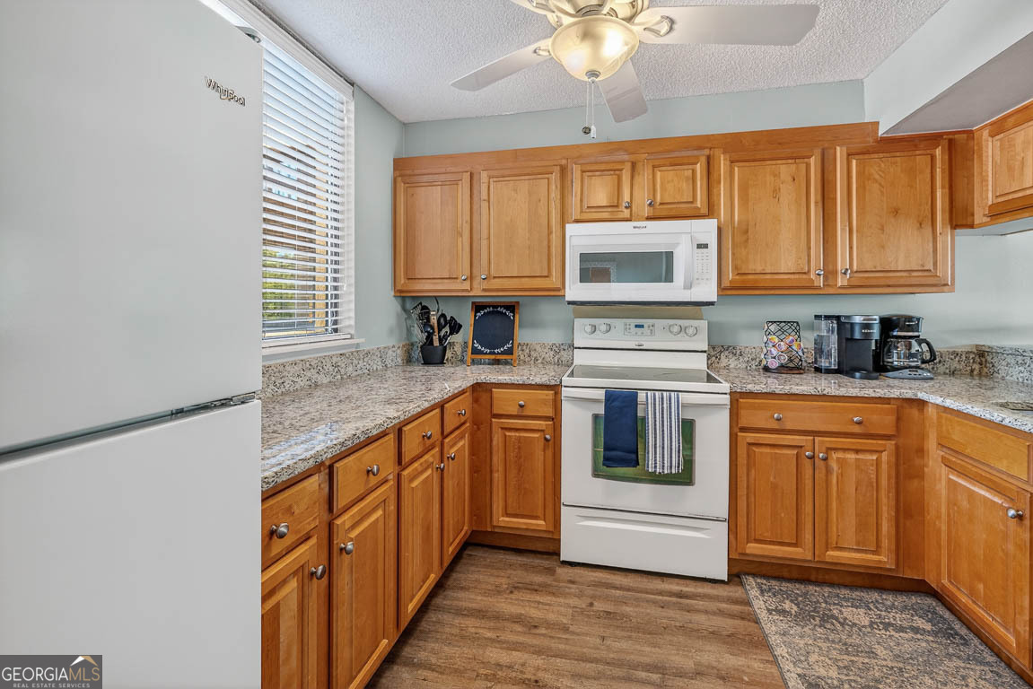 201 Neptune Road, Unit 258 St. Simons, GA 31522 - Photo 2 of 52 a kitchen with stainless steel appliances granite countertop a stove a sink and a microwave