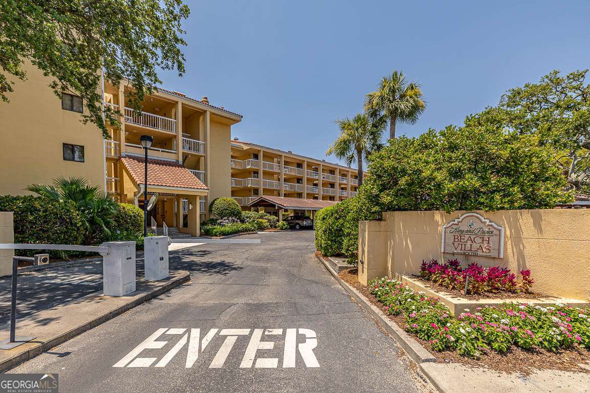 201 Neptune Road, Unit 258 St. Simons, GA 31522 - Photo 2 of 48 a front view of a house with a yard and a garage
