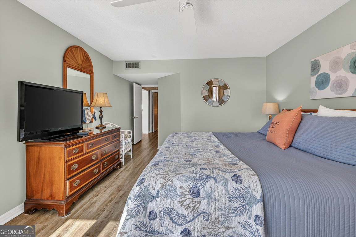 201 Neptune Road, Unit 258 St. Simons, GA 31522 - Photo 21 of 52 a bedroom with a bed and a flat screen tv