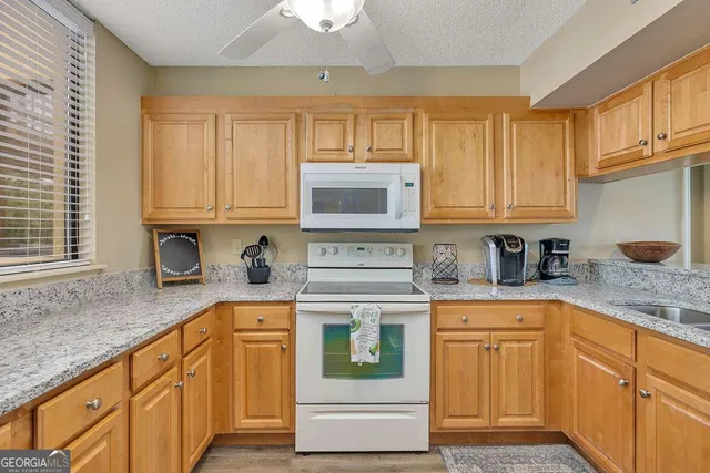a kitchen with stainless steel appliances granite countertop a stove and cabinets
