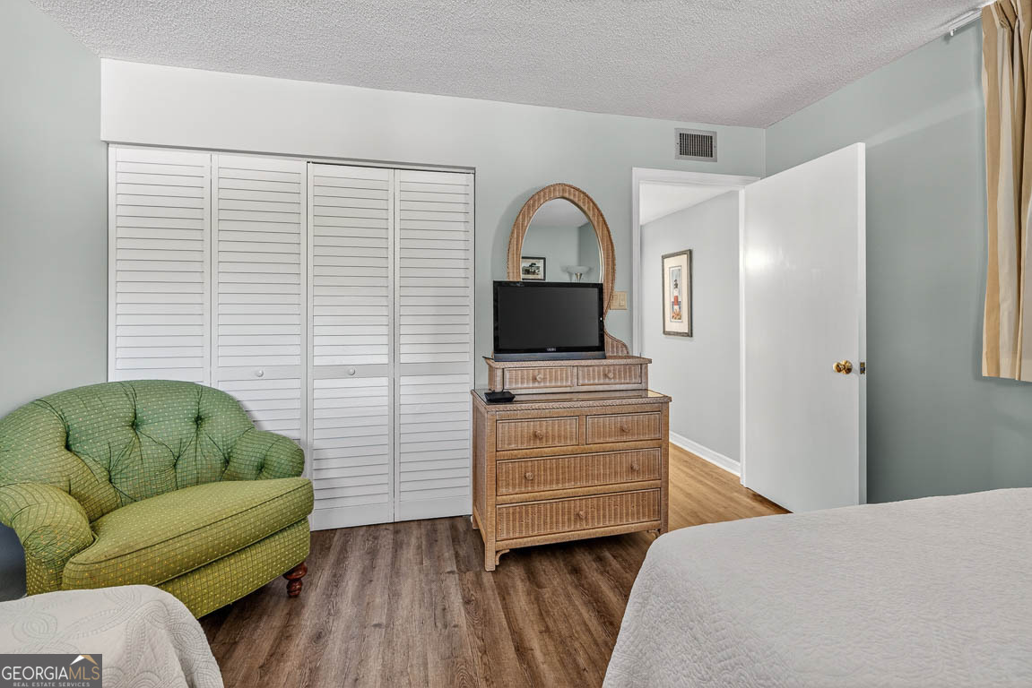 201 Neptune Road, Unit 258 St. Simons, GA 31522 - Photo 24 of 52 a bedroom with furniture and a flat screen tv