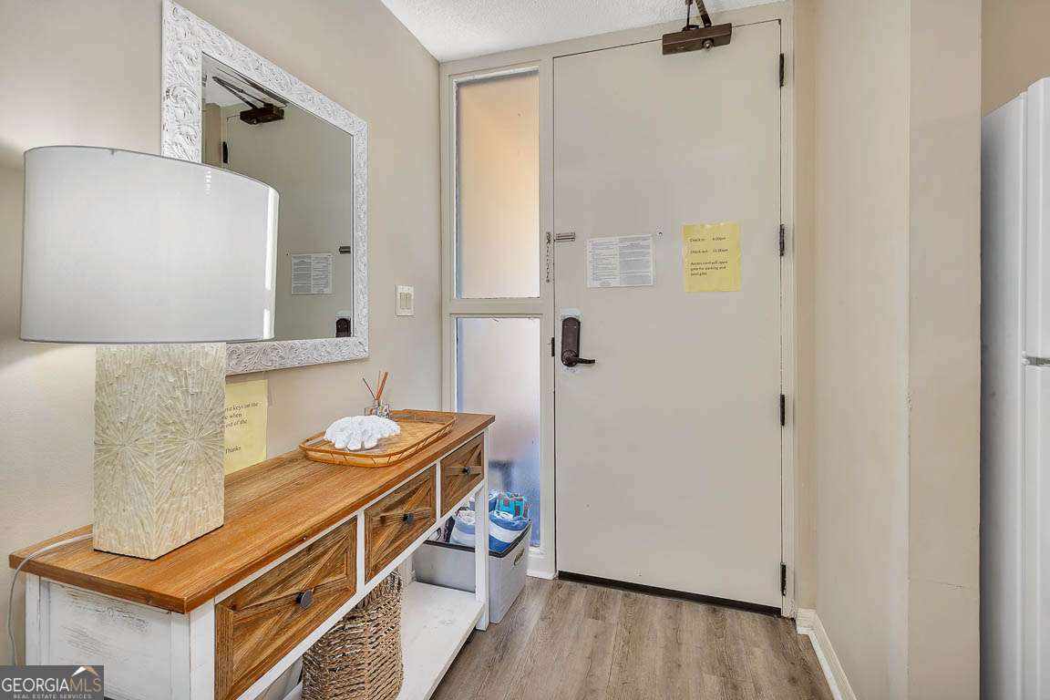 201 Neptune Road, Unit 258 St. Simons, GA 31522 - Photo 3 of 48 a bathroom with a sink a mirror and a shower
