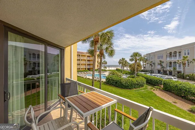 a view of a balcony with two chairs and a table