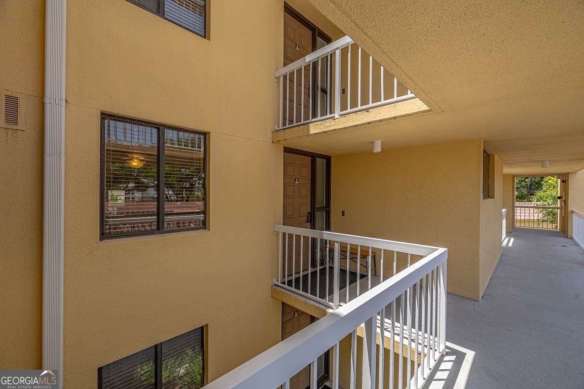 201 Neptune Road, Unit 258 St. Simons, GA 31522 - Photo 43 of 52 a view of staircase with railing and a window