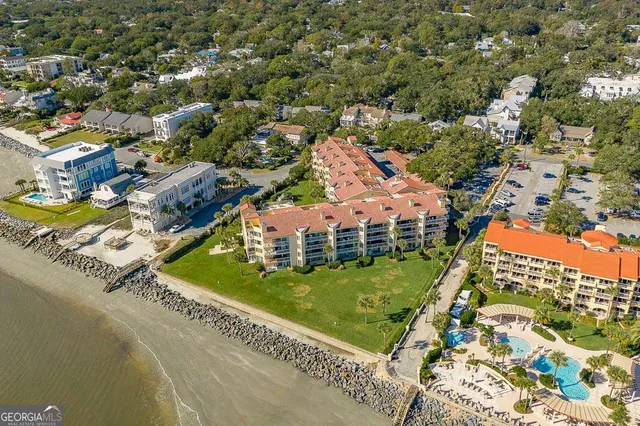 an aerial view of residential houses with outdoor space and swimming pool
