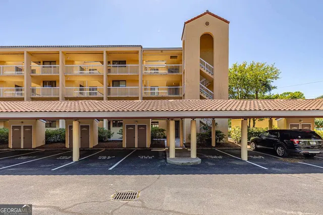 a front view of a building with parking space and windows