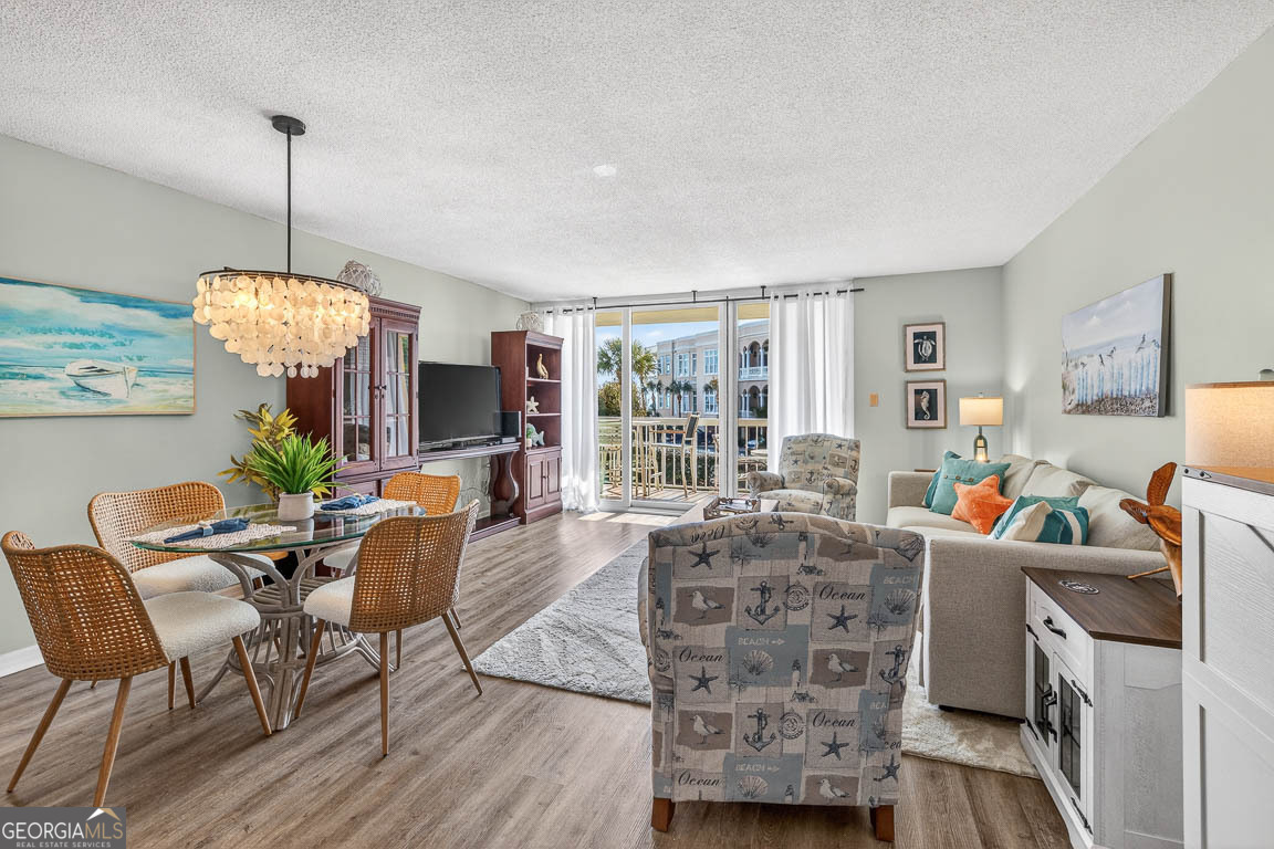 201 Neptune Road, Unit 258 St. Simons, GA 31522 - Photo 6 of 52 a view of a dining room with furniture window and wooden floor