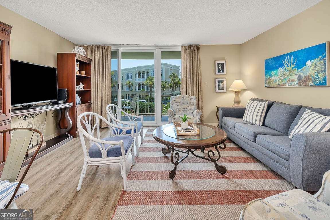 201 Neptune Road, Unit 258 St. Simons, GA 31522 - Photo 6 of 48 a living room with furniture and a flat screen tv
