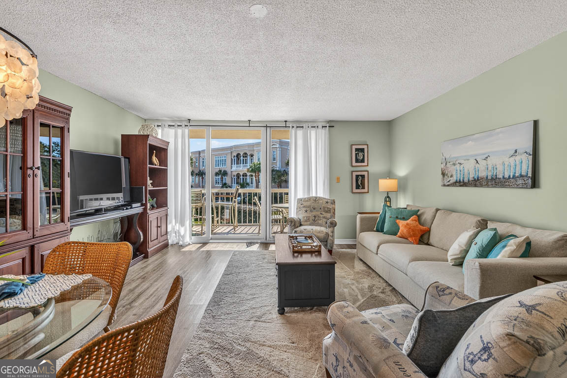 201 Neptune Road, Unit 258 St. Simons, GA 31522 - Photo 7 of 52 a living room with furniture and a flat screen tv