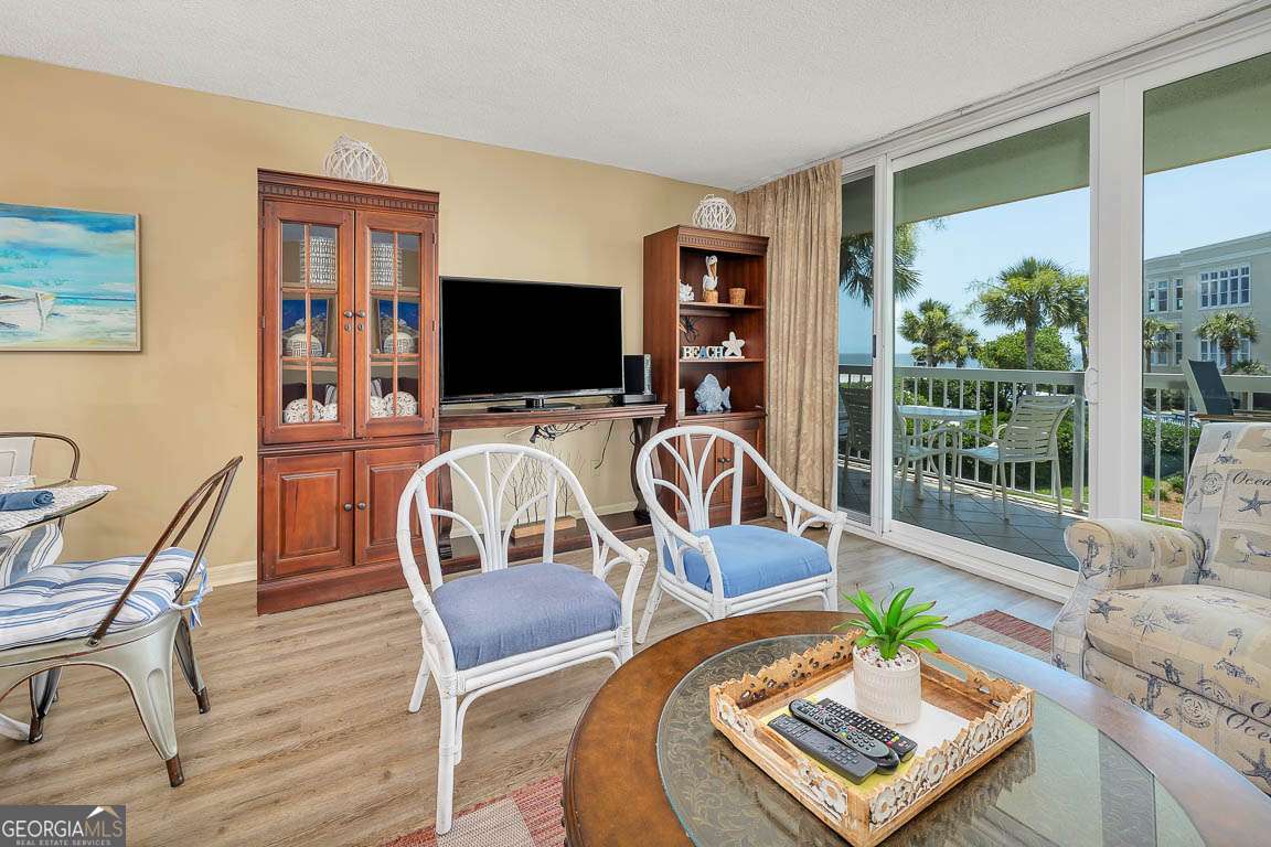 201 Neptune Road, Unit 258 St. Simons, GA 31522 - Photo 8 of 48 a living room with furniture and a flat screen tv