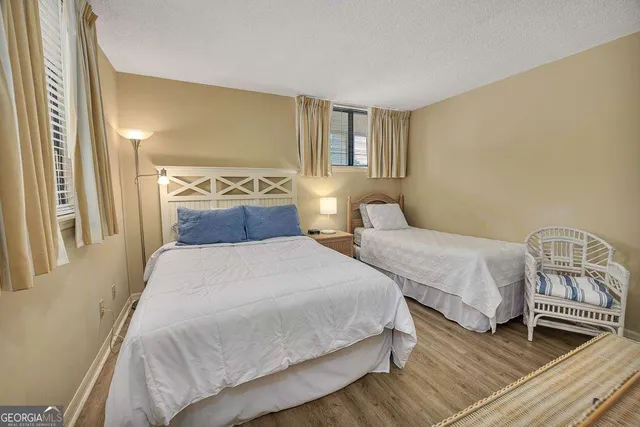 a bedroom with two beds and painting on the wall