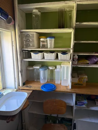 a bedroom with a bed a window and dresser