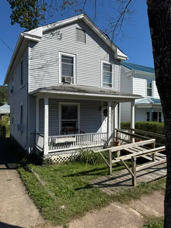 a view of a brick house with stairs and wooden floor