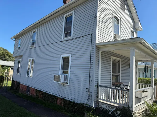 a view of a chairs and table in the balcony