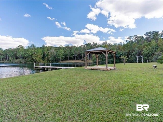 4650 Wiggins Lane Wilmer, AL 36587 - Photo 34 of 66 Surrounding community with a wooded view, a yard, and a water view
