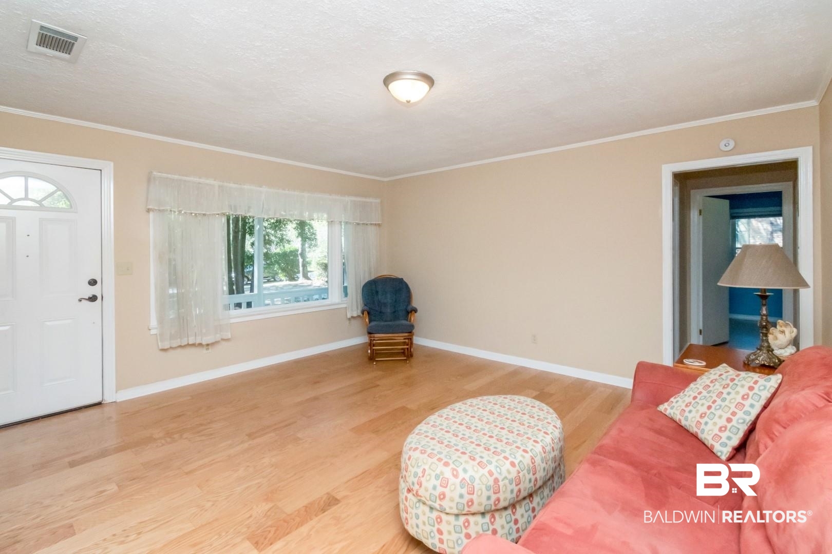 1321 Rainbow Drive West Mobile, AL 36693 - Photo 6 of 48 Interior space featuring ornamental molding, hardwood / wood-style flooring, and a textured ceiling