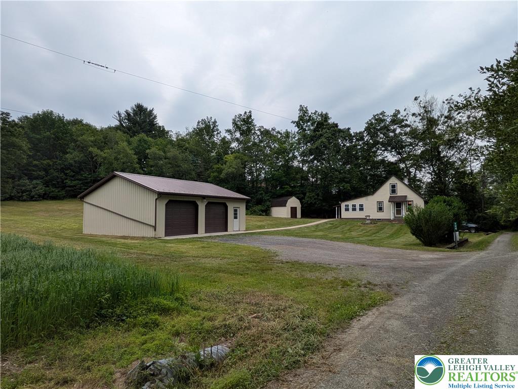 124 Sterling Valley Road Kunkletown, PA 18058 - Photo 1 of 29 a front view of house with yard and trees in the background