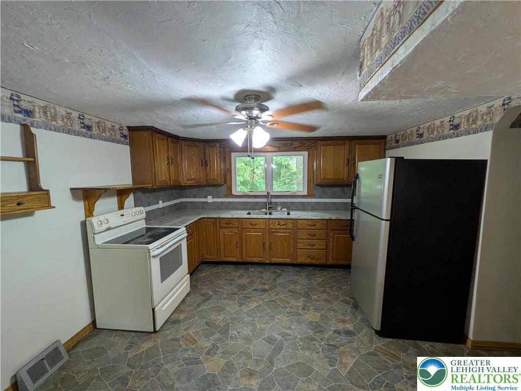 124 Sterling Valley Road Kunkletown, PA 18058 - Photo 14 of 29 a kitchen with stainless steel appliances a stove a refrigerator and a sink