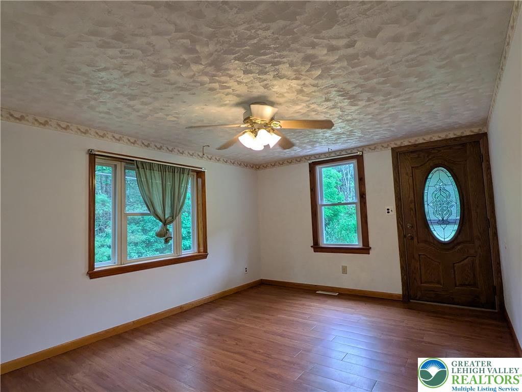 124 Sterling Valley Road Kunkletown, PA 18058 - Photo 19 of 29 an empty room with wooden floor closet and windows
