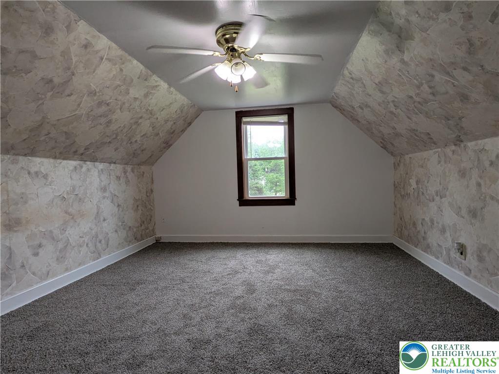 124 Sterling Valley Road Kunkletown, PA 18058 - Photo 23 of 29 an empty room with a chandelier fan and windows